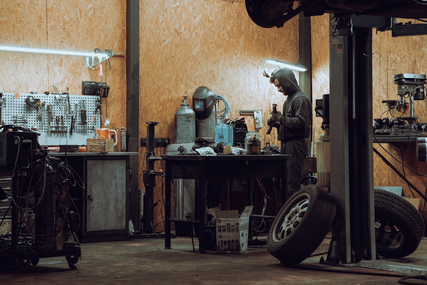 A wide view of an independent workshop, with a technician at the bench